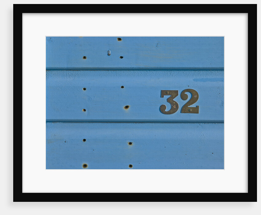 32 Number Sign on Beach hut close-up, Blue Background by Assaf Frank